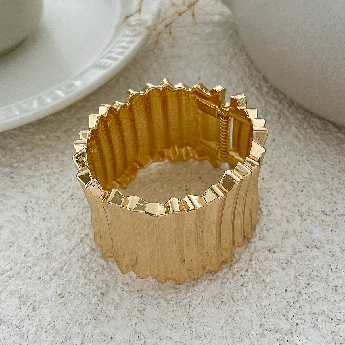 Gold decorative ring on a textured surface