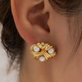 Gold earring with pearls worn by a person
