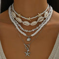 Necklace with shell and pearl elements on a mannequin