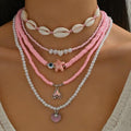 Necklace with pink beads and shell elements on a model