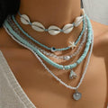 Necklace with shell and starfish pendants on a mannequin