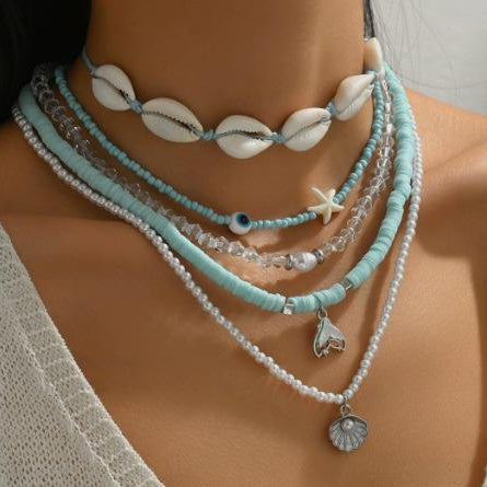 Necklace with shell and starfish pendants on a mannequin