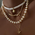 Necklace with starfish pendant and pearl beads on a brown background