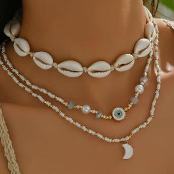 Necklace with shell and bead details on a person's neck