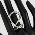 Silver ring on a black mannequin hand against a white background