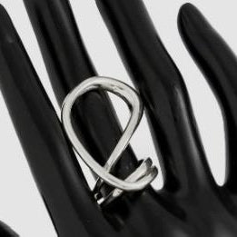 Silver ring on a black mannequin hand against a white background