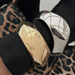 Gold and black makeup case on a leopard print surface