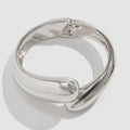 Silver ring on a light gray background