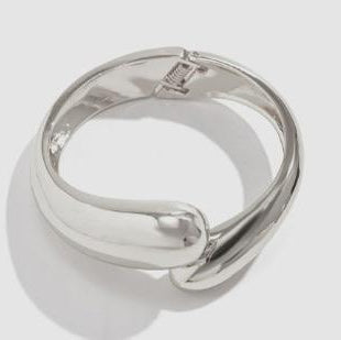 Silver ring on a light gray background