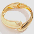 Gold bracelet on a white background
