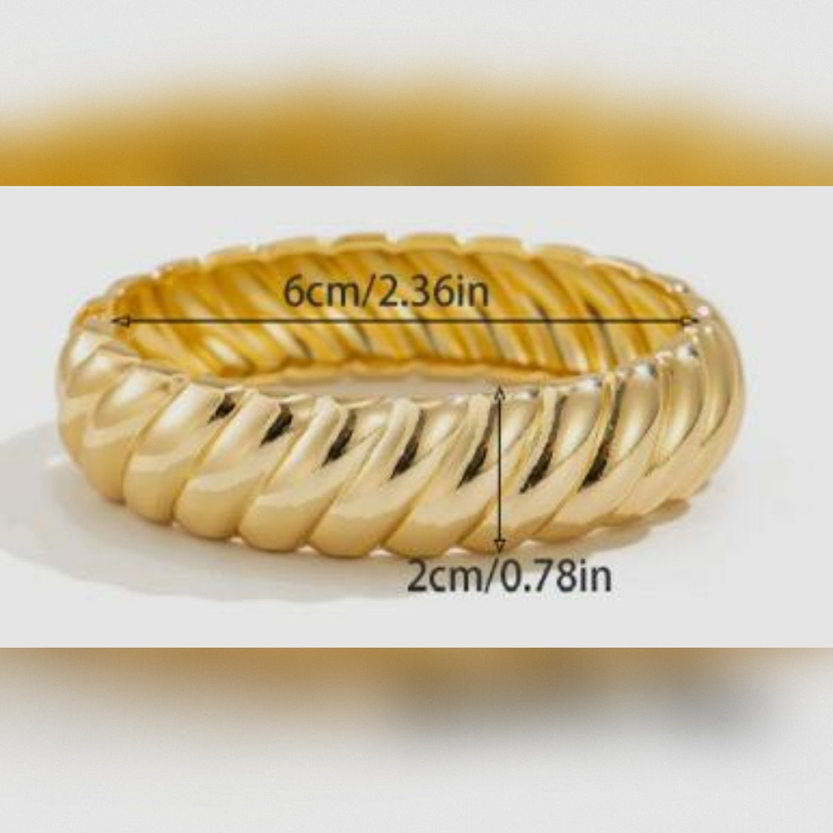Gold ring with measurements on a white background